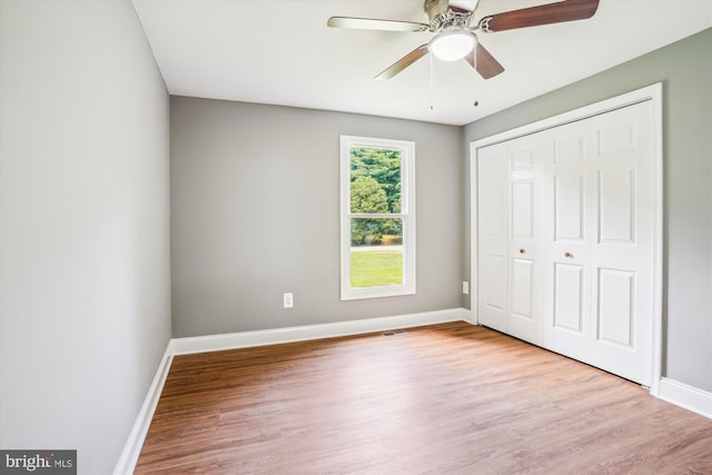 5311 Cove View Dr, Saint Leonard, MD 20685 - unfurnished bedroom featuring wood finished floors, baseboards, a closet, and ceiling fan