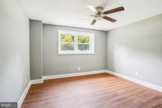 5311 Cove View Dr, Saint Leonard, MD 20685 - empty room with wood finished floors, a ceiling fan, and baseboards