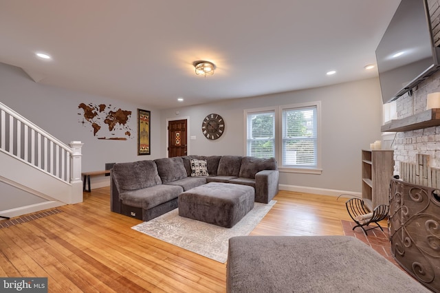 616 New Holland Ave, Lancaster, PA 17602 - living room with stairs, light wood-style floors, a fireplace, and recessed lighting