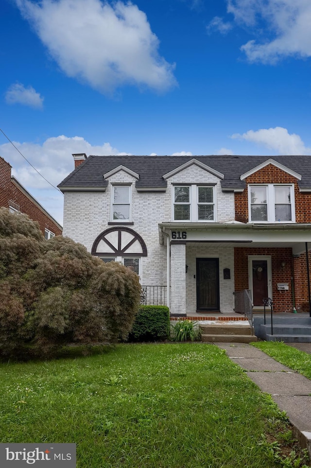 616 New Holland Ave, Lancaster, PA 17602 - view of front facade with a front lawn, brick siding, a porch, and roof with shingles