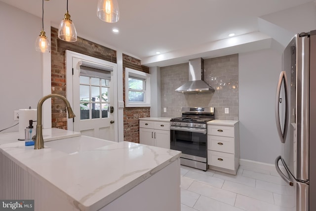 616 New Holland Ave, Lancaster, PA 17602 - kitchen with wall chimney exhaust hood, stainless steel appliances, white cabinetry, decorative backsplash, and a peninsula