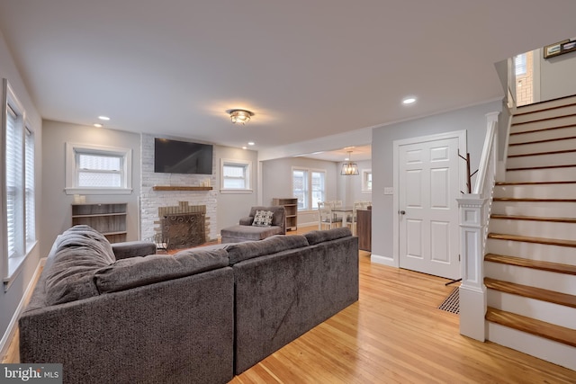 616 New Holland Ave, Lancaster, PA 17602 - living area featuring stairway, light wood finished floors, a brick fireplace, and recessed lighting