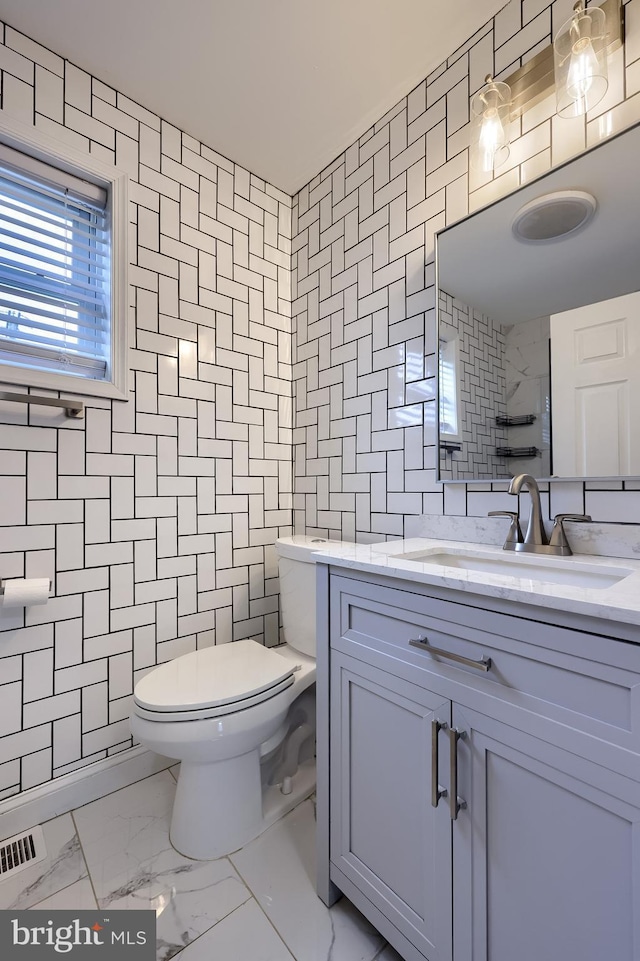 616 New Holland Ave, Lancaster, PA 17602 - bathroom with tile walls, marble look tile flooring, and vanity