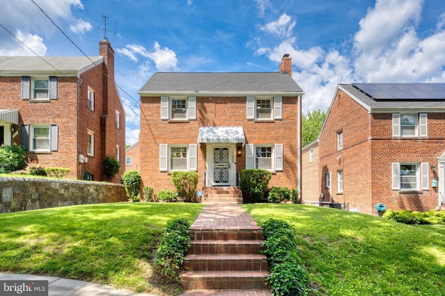 1604 Crittenden St NE, Washington, DC 20017 - view of front of house with a front lawn, a chimney, and brick siding