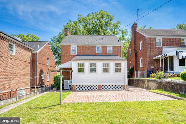 1604 Crittenden St NE, Washington, DC 20017 - back of property featuring cooling unit, a patio area, and a chimney