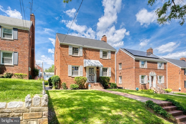 1604 Crittenden St NE, Washington, DC 20017 - view of front of home featuring a front lawn, brick siding, and a chimney