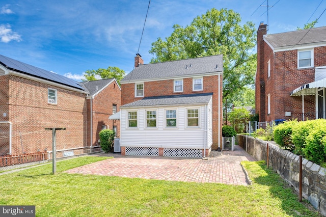 1604 Crittenden St NE, Washington, DC 20017 - rear view of house featuring a chimney, a patio, and central air condition unit