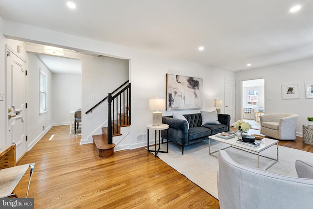 1604 Crittenden St NE, Washington, DC 20017 - living room with light wood-style flooring, recessed lighting, stairway, healthy amount of natural light, and baseboards