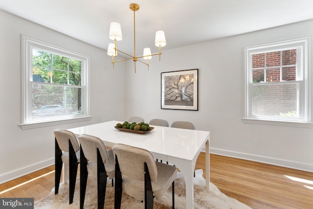 1604 Crittenden St NE, Washington, DC 20017 - dining area with a chandelier, light wood-type flooring, and baseboards