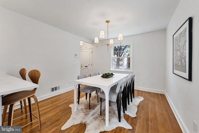1604 Crittenden St NE, Washington, DC 20017 - dining area with a chandelier, wood finished floors, and baseboards