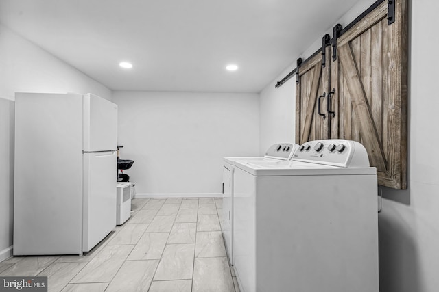 208 N Warwick Rd, Magnolia, NJ 08049 - laundry room featuring independent washer and dryer, a barn door, recessed lighting, light marble finish floors, and baseboards