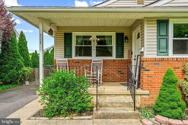 208 N Warwick Rd, Magnolia, NJ 08049 - property entrance featuring covered porch and brick siding