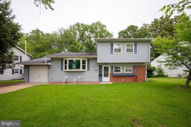 38 Gill Dr, Newark, DE 19713 - tri-level home with concrete driveway, a front lawn, an attached garage, brick siding, and board and batten siding