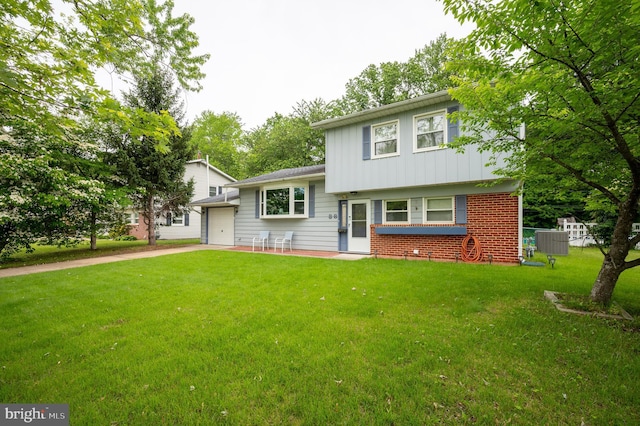 38 Gill Dr, Newark, DE 19713 - tri-level home featuring an attached garage, concrete driveway, board and batten siding, a front lawn, and brick siding