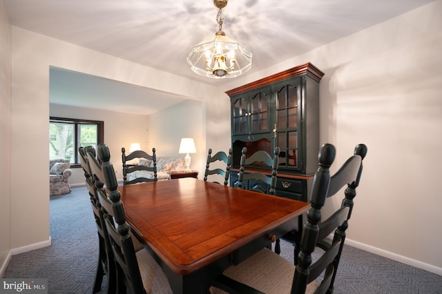 38 Gill Dr, Newark, DE 19713 - dining room with dark carpet, a chandelier, and baseboards