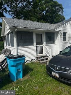 308 Carey Ave, Salisbury, MD 21804 - view of home's exterior with entry steps, a lawn, a shingled roof, and a sunroom