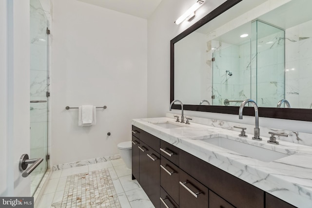 1414 S Penn Sq Unit 28A, Philadelphia, PA 19102 - bathroom featuring double vanity, a marble finish shower, toilet, and baseboards