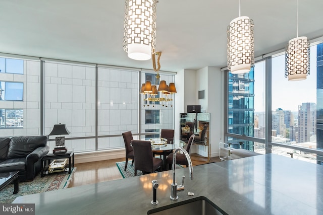 1414 S Penn Sq Unit 28A, Philadelphia, PA 19102 - dining room with wood finished floors, expansive windows, and a city view