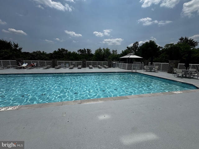 6301 Edsall Rd Unit 224, Alexandria, VA 22312 - community pool featuring a patio, a gazebo, and view of wooded area