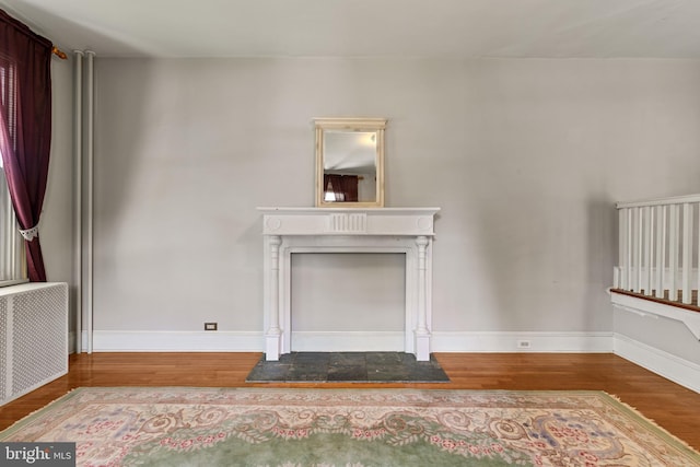 12 E Charles St, Palmyra, NJ 08065 - unfurnished living room with radiator, wood finished floors, and a fireplace