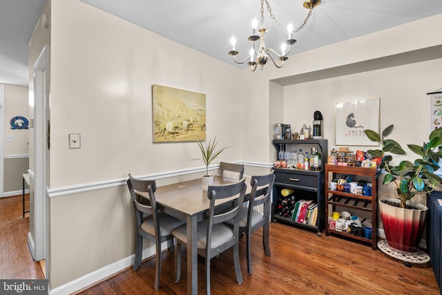 841 Mchenry St, Baltimore, MD 21230 - dining room featuring a chandelier, wood finished floors, and baseboards