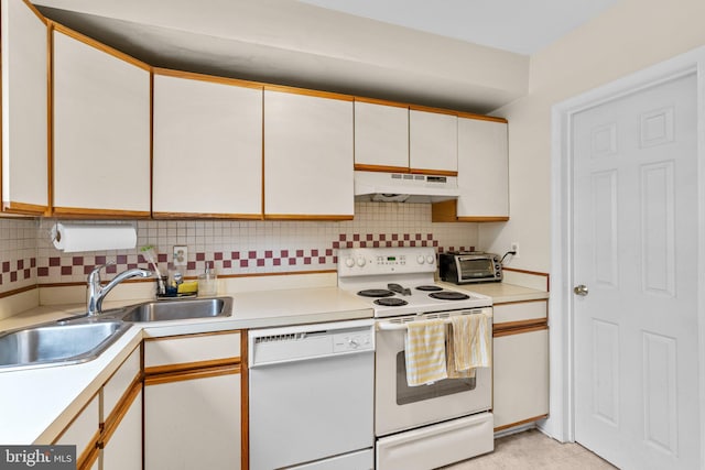 841 Mchenry St, Baltimore, MD 21230 - kitchen with white appliances, under cabinet range hood, a sink, light countertops, and decorative backsplash