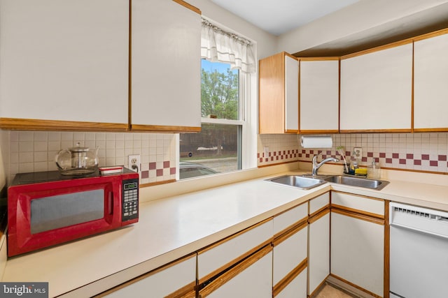 841 Mchenry St, Baltimore, MD 21230 - kitchen with dishwasher, light countertops, backsplash, and white cabinets