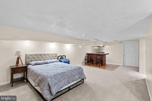 841 Mchenry St, Baltimore, MD 21230 - carpeted bedroom featuring bar, a textured ceiling, and baseboards