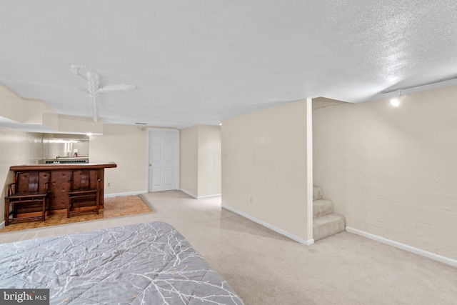 841 Mchenry St, Baltimore, MD 21230 - carpeted bedroom with bar, baseboards, and a textured ceiling
