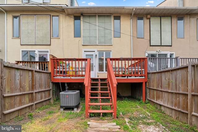 841 Mchenry St, Baltimore, MD 21230 - back of property featuring central air condition unit, stairs, a fenced backyard, a wooden deck, and stucco siding