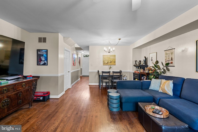 841 Mchenry St, Baltimore, MD 21230 - living room featuring a chandelier, wood finished floors, and baseboards