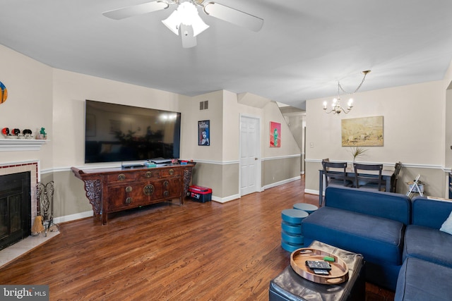 841 Mchenry St, Baltimore, MD 21230 - living room with wood finished floors, a chandelier, a tile fireplace, and a ceiling fan