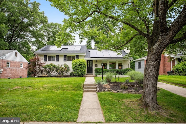 9309 E Parkhill Dr, Bethesda, MD 20814 - tri-level home with a front yard, roof mounted solar panels, and brick siding