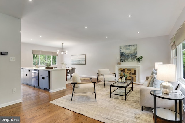 9309 E Parkhill Dr, Bethesda, MD 20814 - living room with plenty of natural light, light wood-style flooring, a chandelier, recessed lighting, and baseboards