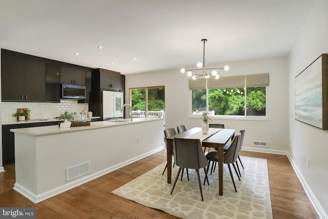 9309 E Parkhill Dr, Bethesda, MD 20814 - dining room featuring a chandelier, light wood-type flooring, baseboards, and recessed lighting