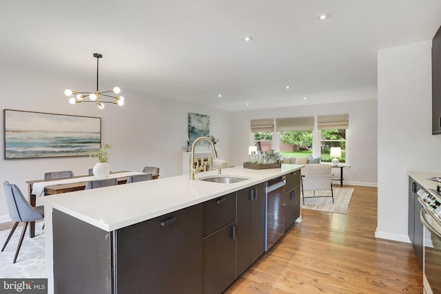9309 E Parkhill Dr, Bethesda, MD 20814 - kitchen with a sink, stainless steel dishwasher, light countertops, open floor plan, and light wood-style flooring