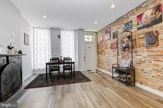 107 W Ostend St, Baltimore, MD 21230 - dining space with baseboards, wood finished floors, brick wall, and recessed lighting