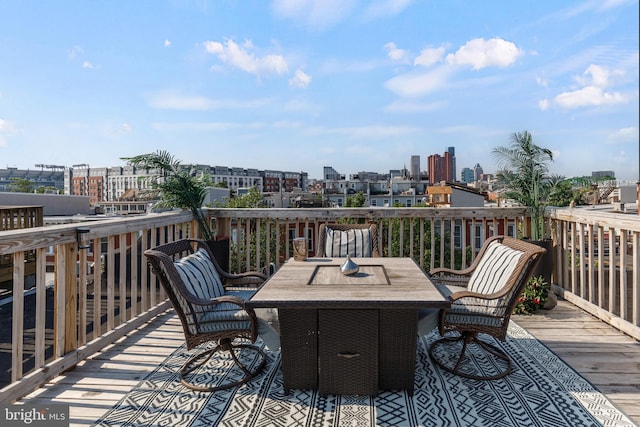107 W Ostend St, Baltimore, MD 21230 - wooden terrace featuring a city view and outdoor dining space