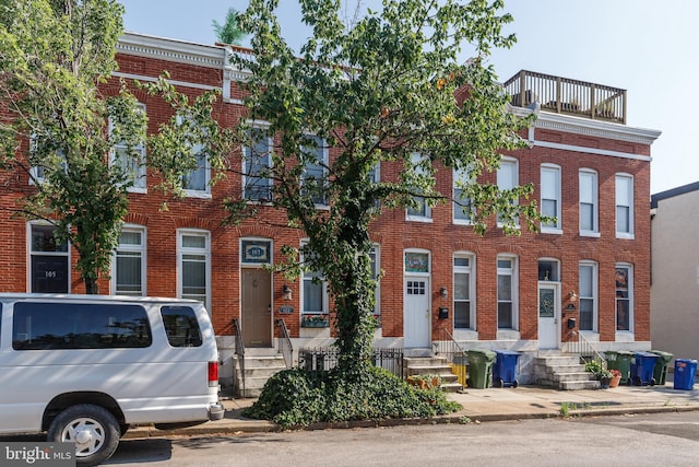 107 W Ostend St, Baltimore, MD 21230 - townhome / multi-family property featuring brick siding and entry steps