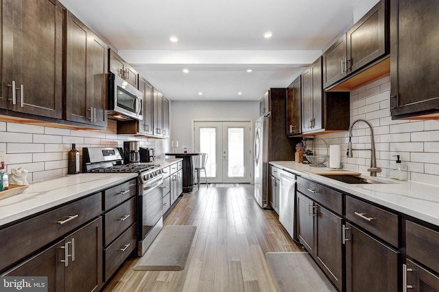 107 W Ostend St, Baltimore, MD 21230 - kitchen with appliances with stainless steel finishes, a sink, french doors, dark brown cabinetry, and recessed lighting