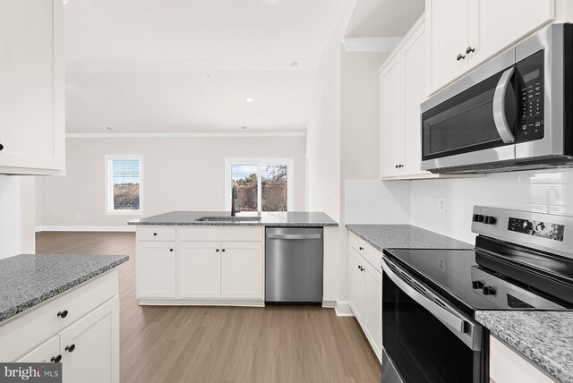 5205 Mccormick Ave, Baltimore, MD 21206 - kitchen with stainless steel appliances, ornamental molding, a sink, light wood finished floors, and white cabinetry
