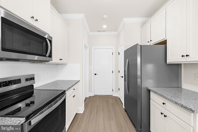 5205 Mccormick Ave, Baltimore, MD 21206 - kitchen with appliances with stainless steel finishes, light wood-style floors, white cabinetry, ornamental molding, and decorative backsplash