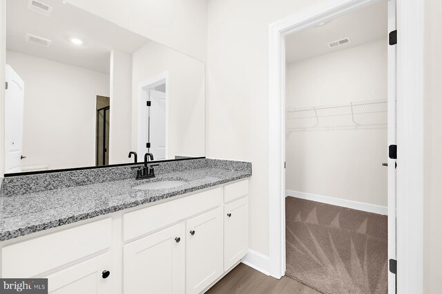 5205 Mccormick Ave, Baltimore, MD 21206 - full bath featuring vanity, a shower stall, a spacious closet, baseboards, and recessed lighting