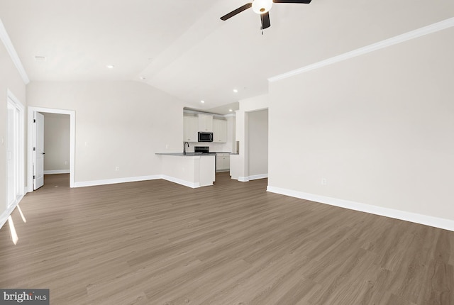 5205 Mccormick Ave, Baltimore, MD 21206 - unfurnished living room featuring ceiling fan, baseboards, lofted ceiling, light wood-style flooring, and ornamental molding