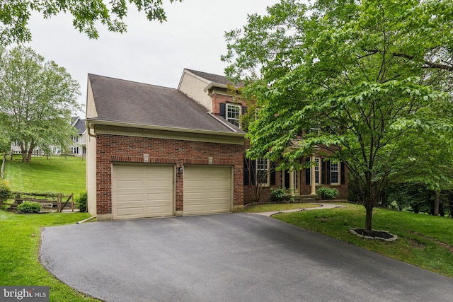 702 Iris Ln, Media, PA 19063 - view of front facade featuring asphalt driveway, a front lawn, brick siding, an attached garage, and a shingled roof