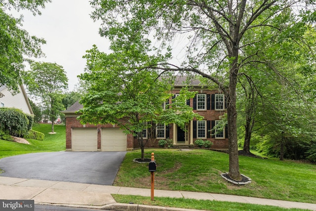 702 Iris Ln, Media, PA 19063 - view of front of house featuring brick siding, driveway, a front lawn, and a garage