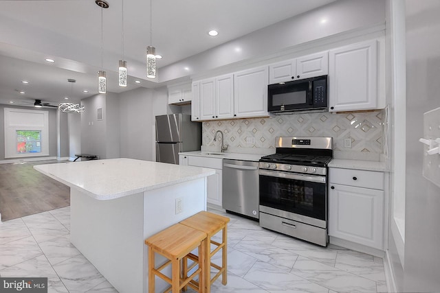 538 N Lakewood Ave, Baltimore, MD 21205 - kitchen featuring appliances with stainless steel finishes, light marble finish flooring, a sink, a breakfast bar area, and recessed lighting