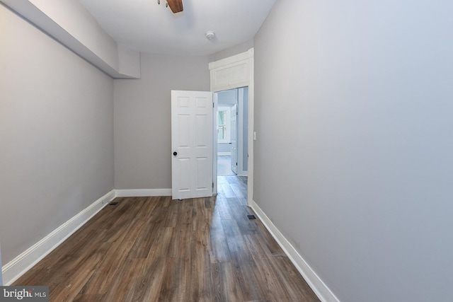 538 N Lakewood Ave, Baltimore, MD 21205 - unfurnished room featuring dark wood-style floors, baseboards, a smoke detector, and a ceiling fan