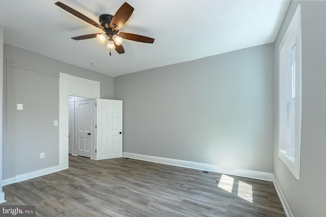 538 N Lakewood Ave, Baltimore, MD 21205 - unfurnished bedroom with baseboards, wood finished floors, and a ceiling fan