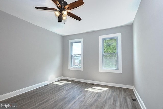 538 N Lakewood Ave, Baltimore, MD 21205 - spare room featuring dark wood-type flooring, ceiling fan, and baseboards